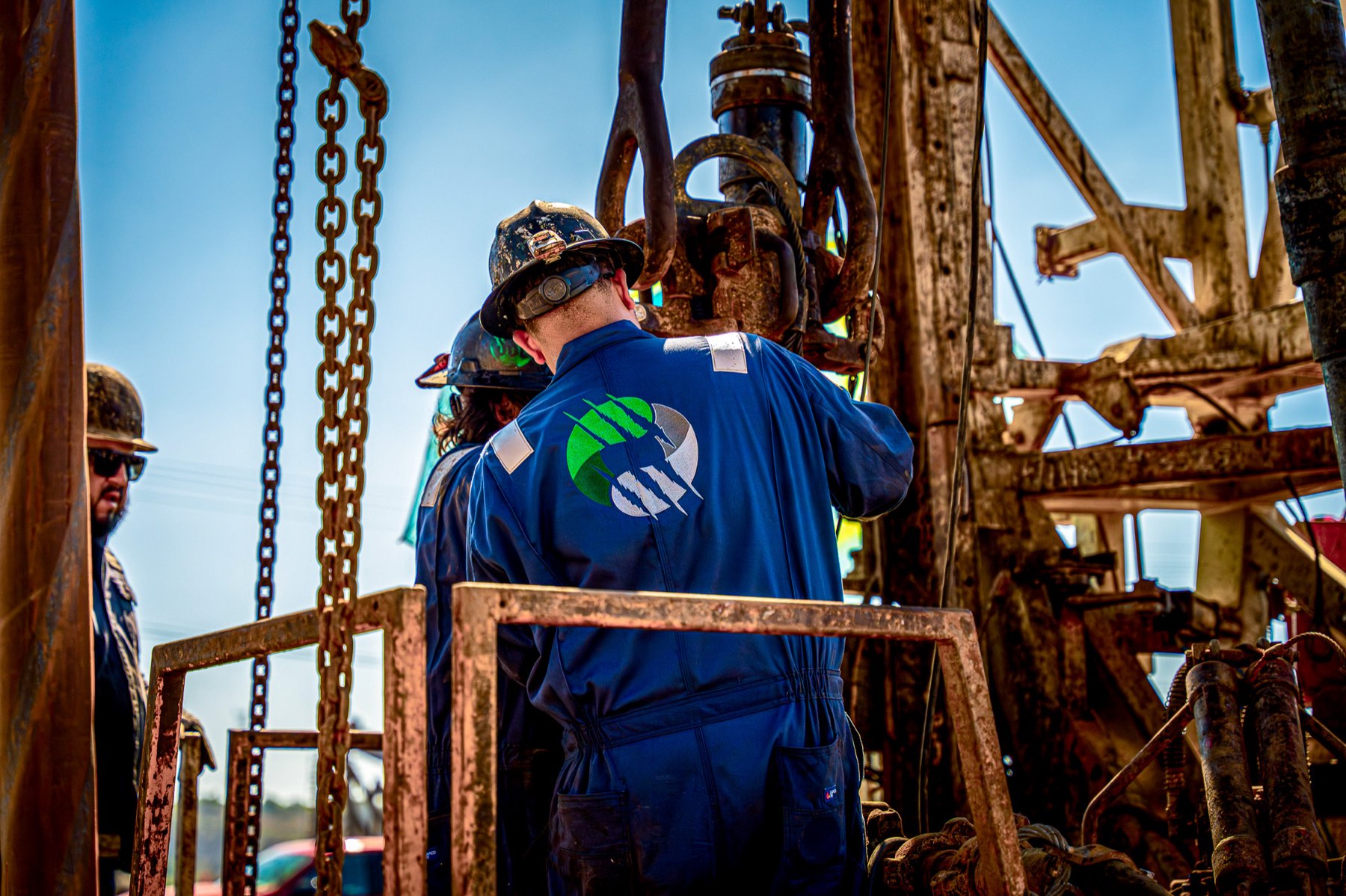 Crew member working the wireline at the rig